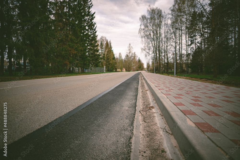 Fototapeta premium asphalt road, concrete brick pavement, perspective
