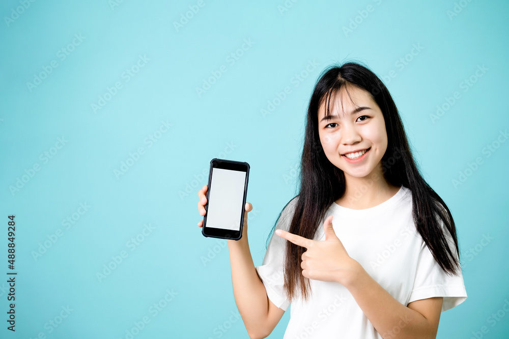 Portrait of happy young woman pointing at blank white screen on smartphone Portrait of happy young woman pointing at blank white screen on smartphone