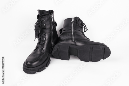 Black youth light boots with high soles for cool spring weather with rain on a light background with light shade