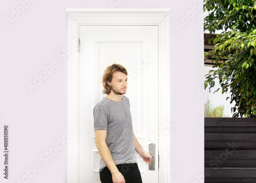 man opening the door of his home.
