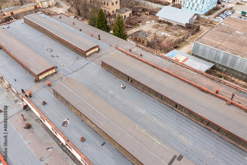 The roof of the old industrial plant building in Kiev. Aerial drone view. The roof of the old industrial plant building in Kiev. Aerial drone view.