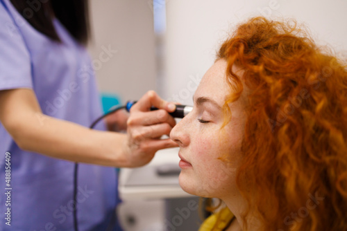 Female patient checking the eye pressure at her local clinic