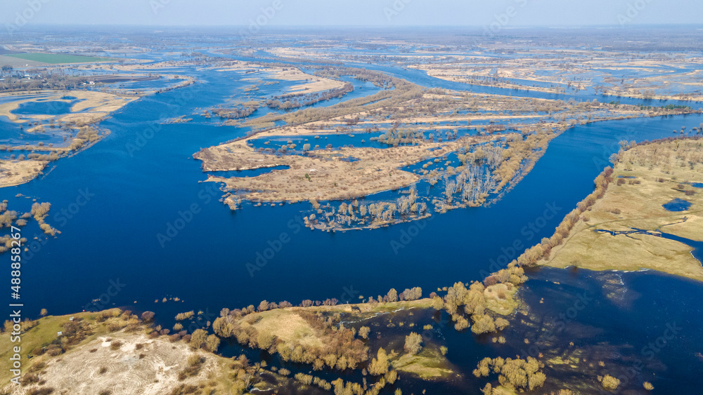 Aerial view flooded forest and fields. The high waters flooded a big area of farm land. Aerial view flooded forest and fields. The high waters flooded a big area of farm land.