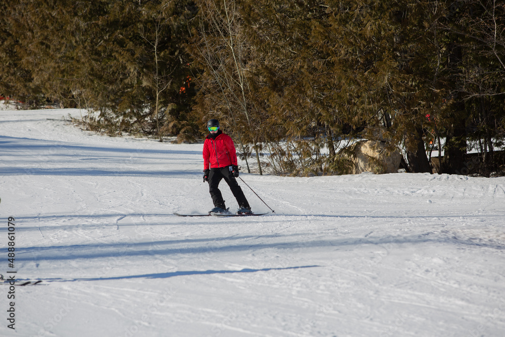 Skier going down the hill. Downhill skiing.