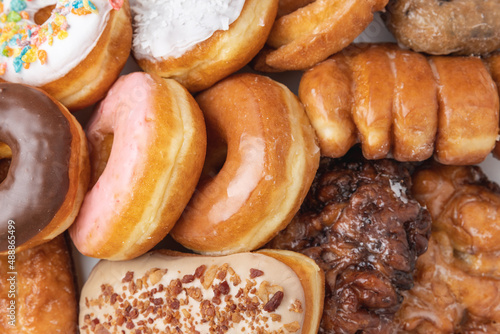 Overhead shot of a box of assorted donuts indoors under studio lighting. photo