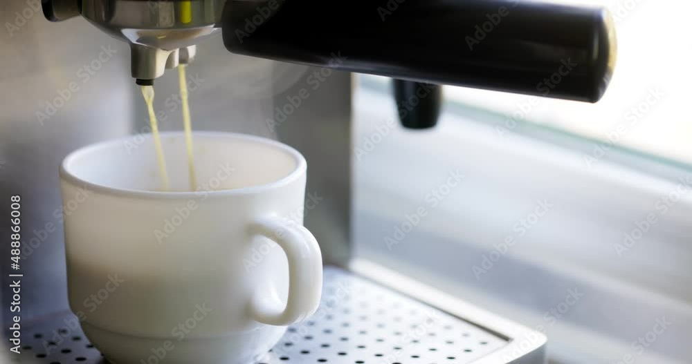 Making coffee espresso or ristretto in coffee machine. Home making hot espresso. Coffee with froth. Espresso in a white cup. Beverage drink for breakfast Making coffee espresso or ristretto in coffee machine. Home making hot espresso. Coffee with froth. Espresso in a white cup. Beverage drink for breakfast