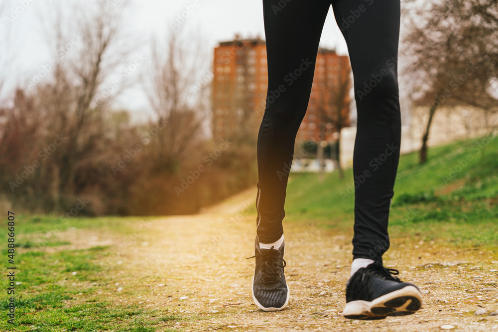 closeup of person running in the morning in a park closeup of person running in the morning in a park