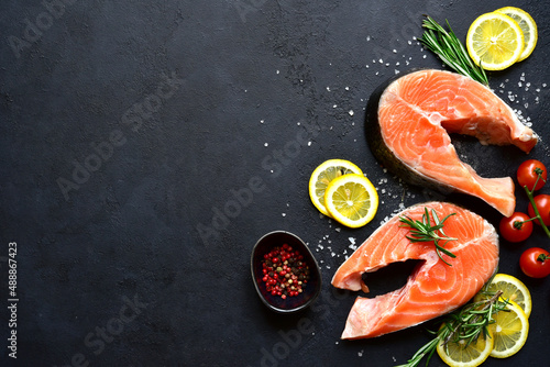 Raw organic salmon steak with ingredients for making : lemon, spices and vegetables. Top view with copy space.