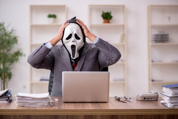 Devil businessman employee sitting at workplace