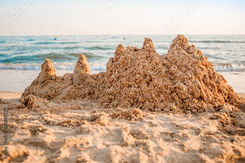 Sand castle on a sandy sea beach