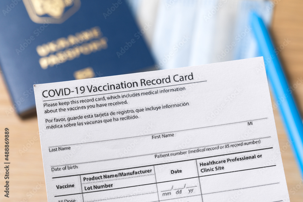 COVID-19 vaccination record card and tourist passport for worldwide travel during coronavirus pandemic. - Image COVID-19 vaccination record card and tourist passport for worldwide travel during coronavirus pandemic. - Image
