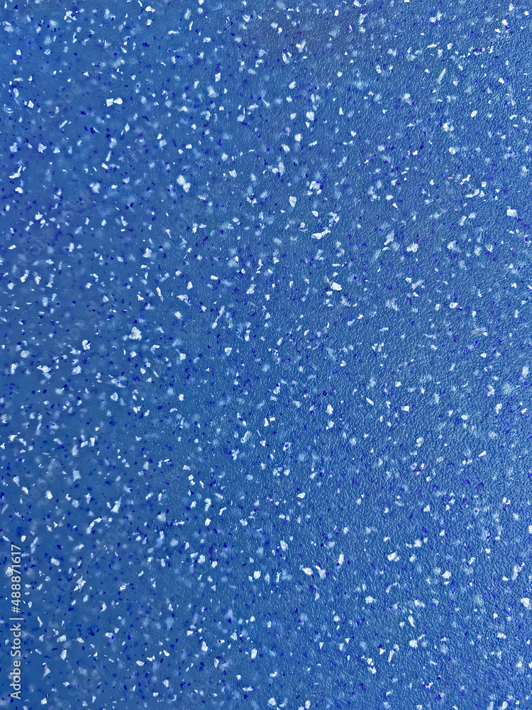 close up of blue plastic board with crumbs pattern