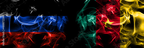 Donetsk People s Republic vs Cameroon  Cameroonian flag. Smoke flags placed side by side isolated on black background.