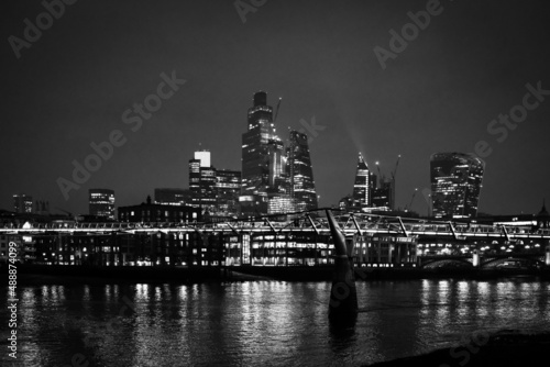 Black and White night shot of City of London Skyline with Millenium Bridge in January 2022