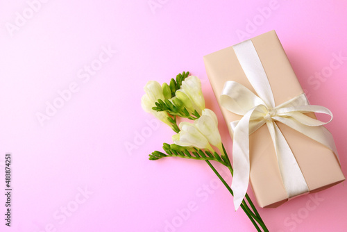 Gift box and spring flowers on pink background. Stylish soft image of spring flowers. Happy womens day. Happy Mothers day.Hello Spring- Image © Fototocam