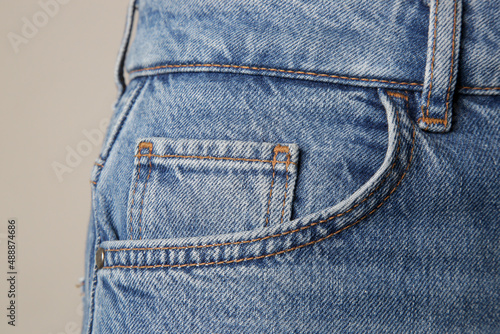 Tiny front pocket on denim pants, close up. photo