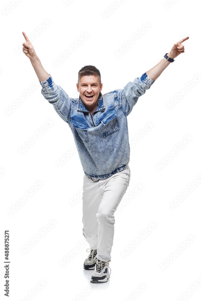 man in denim jacket celebrating success with hands up in the air man in denim jacket celebrating success with hands up in the air
