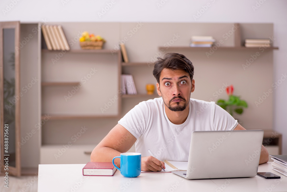 Young male employee working from home during pandemic Young male employee working from home during pandemic