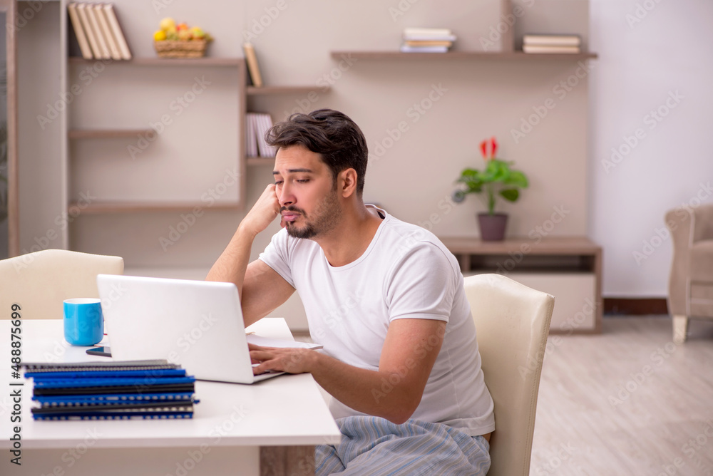 Young male employee working from home during pandemic Young male employee working from home during pandemic