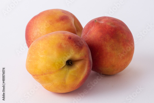 fresh peaches on a white meza photo