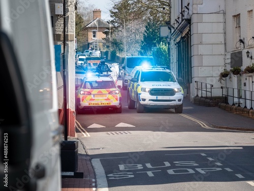Photography Two police cars blocking the road at emergency scene with blue flashing lights
