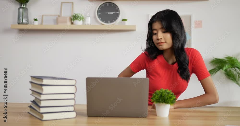 Portrait of Asian schoolgirl studying online via laptop at home. Distance learning and education concept. Portrait of Asian schoolgirl studying online via laptop at home. Distance learning and education concept.
