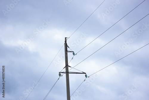 Power lines against the sky. Wires on electric poles against the gray sky. High voltage wires electricity.