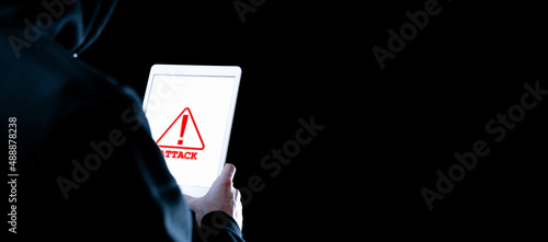 Fototapeta Naklejka Na Ścianę i Meble -  Hacker attack tablet cyber security. Digital mobile phone in hacker man hand isolated on black. Internet web hack technology. Login and password, cybersecurity banner concept.
