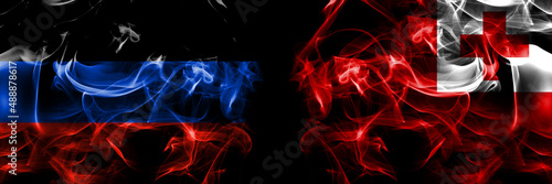Donetsk People's Republic vs Tonga flag. Smoke flags placed side by side isolated on black background.