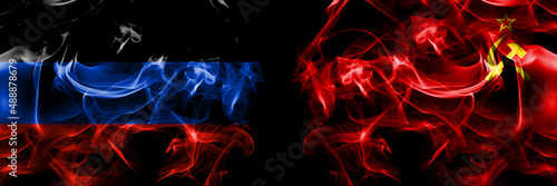 Donetsk People s Republic vs USSR  Soviet  Russia  Russian  Communism flag. Smoke flags placed side by side isolated on black background.