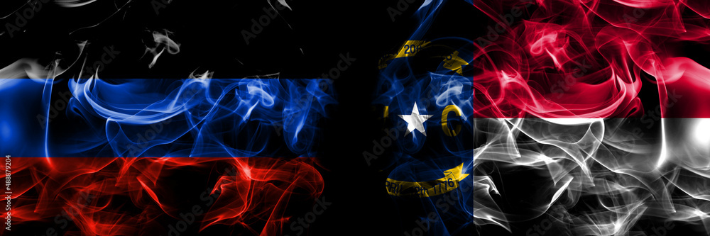 Donetsk People's Republic vs United States of America, America, US, USA, American, North Carolina flag. Smoke flags placed side by side isolated on black background.
