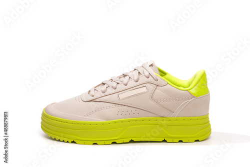 neon-soled sneakers on white background - Image