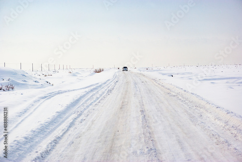 Car driving on a snowy road, Aksu Prefecture, Xinjiang, China © JUAN