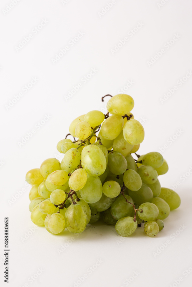 green grapes on white table, white background