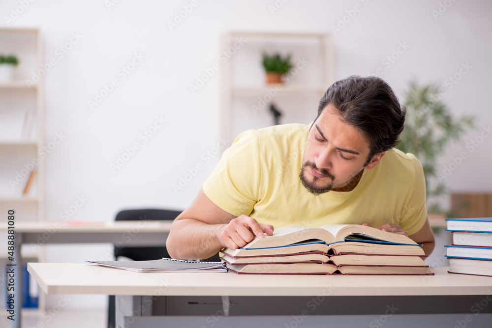 Young male student preparing for exams in the classroom Young male student preparing for exams in the classroom