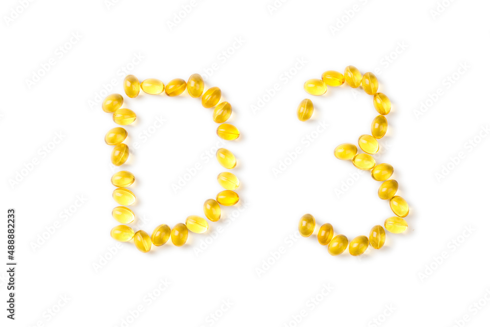 Yellow oil capsules with vitamin D poured from a plastic white bottle and forming shape D3 on the white background. - Image Yellow oil capsules with vitamin D poured from a plastic white bottle and forming shape D3 on the white background. - Image