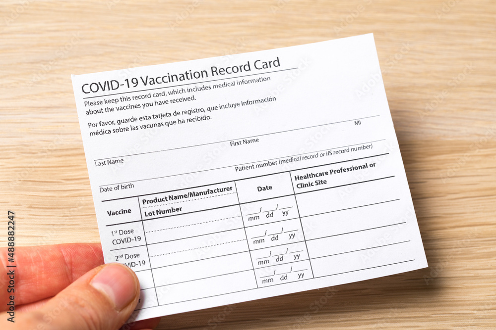 Syringe and vaccine vial for corona virus are on medical form required for travel and tourism. - Image Syringe and vaccine vial for corona virus are on medical form required for travel and tourism. - Image
