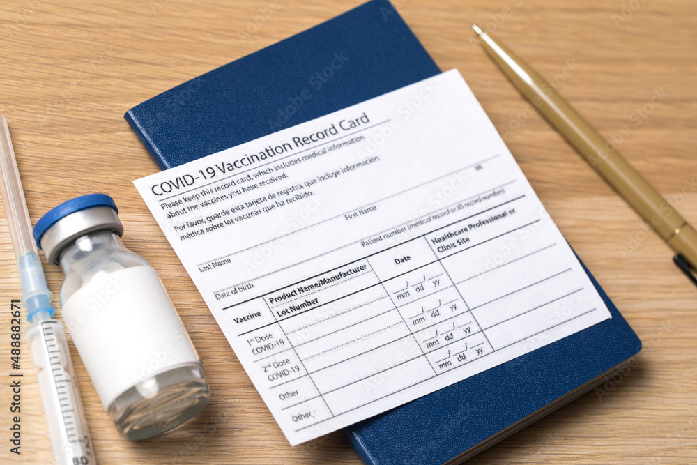 COVID 19 vaccination record card and tourist passport for worldwide