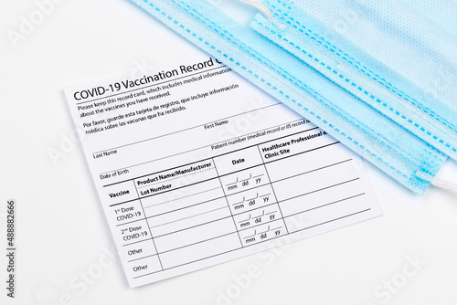 Wallpaper Mural Coronavirus vaccination record card. Protective mask divided into two parts. Concept of defeating Covid-19 - Image Torontodigital.ca