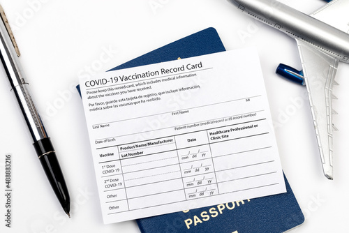 COVID-19 vaccination record card and tourist passport of traveler for worldwide travel during coronavirus pandemic. - Image