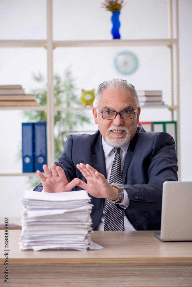 Old male employee and too much work in the office Old male employee and too much work in the office