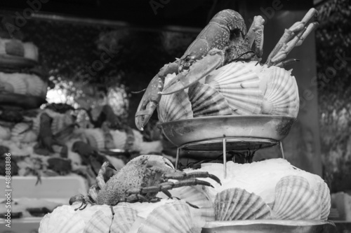 Fresh seafood pyramid at traditional seafood restaurant in Paris, France. Outdoor terrace. Black white historic photo.