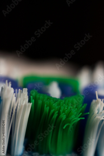 Close up of a colorful toothbrush on black background