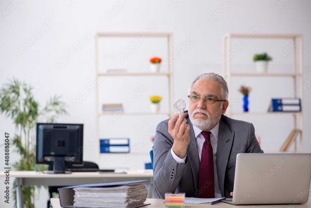 Old male employee in happy idea concept Old male employee in happy idea concept
