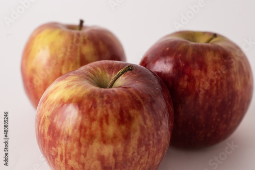 fresh red apples on a white table