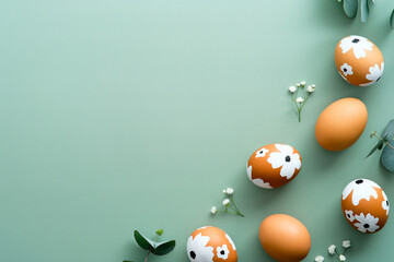 Easter flat lay composition. Easter eggs with flowers and eucalyptus leaves on pastel green background. Happy Easter card design, template.