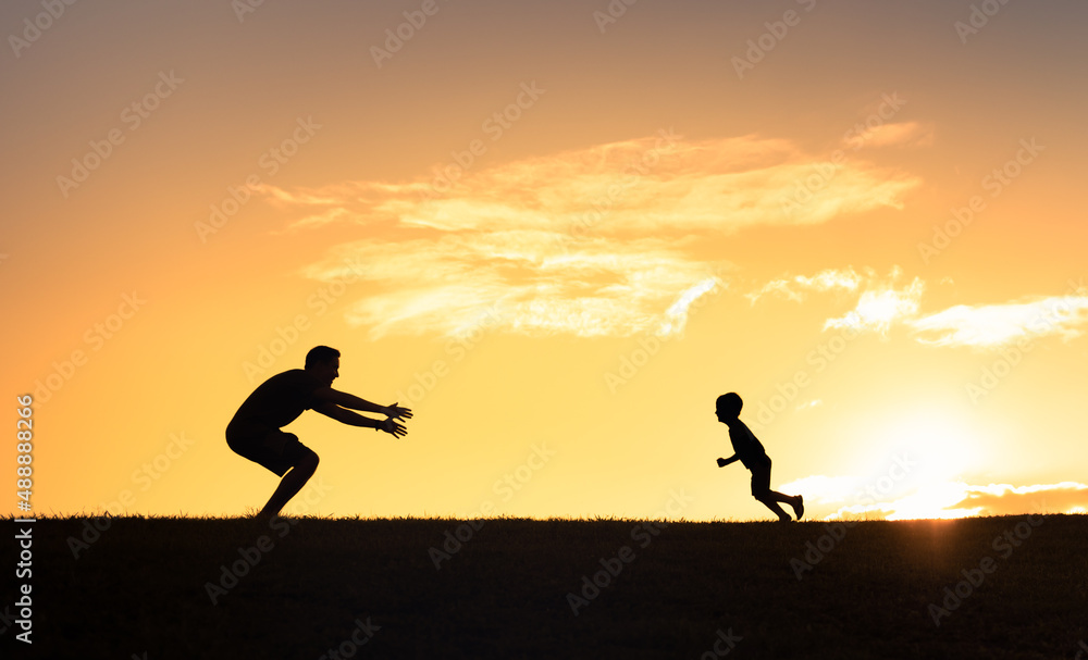 Happy little boy running to hug his dad. Father son relationship concept Happy little boy running to hug his dad. Father son relationship concept