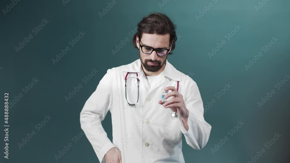 A young doctor shows an ampule with vaccine A young doctor shows an ampule with vaccine