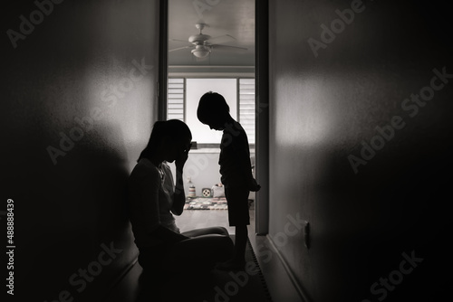 Sad single mother and child at home. Troubled family life concept