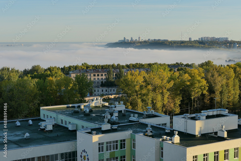 Fototapeta premium Fog over the city in the morning. Autumn morning fog.